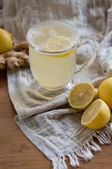 Lemon ginger drink in dark light with a soft cloth and texture