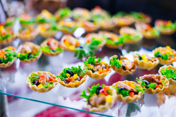 close up of delicious appetizer in tart on a transparent stand.