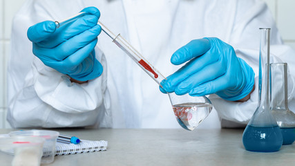 Fototapeta premium Biochemist or virologist doing blood tests