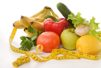vegetables, fruits and herbs, measuring tape on a white background, tomato, lemon, lettuce, Apple, cucumber, garlic, pepper, banana, parsley
