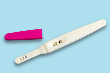 Pregnancy test isolated on blue background