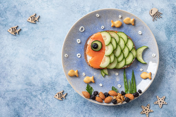 Funny salmon fish sandwich with cucumber for kids lunch