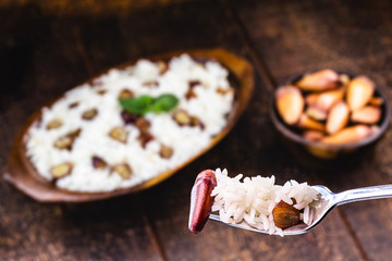 Pine nuts with rice in a graph, food closeup. Pinaceaes and araucariaceaes seeds used in Brazilian cuisine, in a typical dish called 