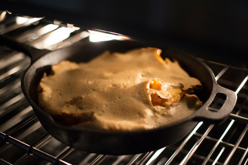 peach oven pancake cooking in the oven