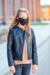 Girl wearing a mask protect against Coronavirus and gripp