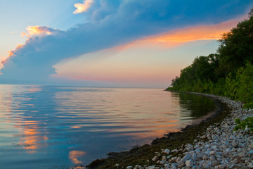 Sunset on Rocky Beach on Green Bay, Lake Michigan at Olde Rock Quarry County Park, Sturgeon Bay, Door County, Wisconsin, USA - obrazy, fototapety, plakaty