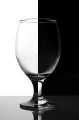 glass wine glass symmetrically divided into white and black halves
