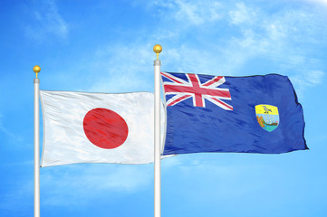 Japan and Saint Helena two flags on flagpoles and blue cloudy sky