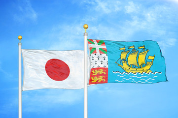Japan and Saint Pierre and Miquelon two flags on flagpoles and blue cloudy sky