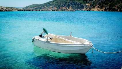 Small fisherboat laying in clear blue water Greece Kos