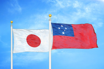 Japan and Samoa two flags on flagpoles and blue cloudy sky