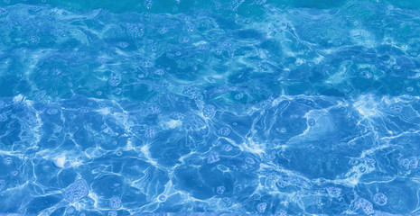 Fototapeta na wymiar Abstract background of blue water surface close up.