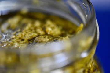 Selective focus shot of pesto in a jar 