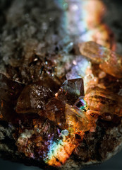 Amazing natural light reflections on healing Smokey Quartz wild jewels. Texture of gemstone with rainbow effect.
