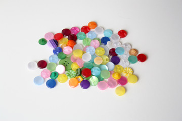 Bright mother-of-pearl buttons for clothes on a white background