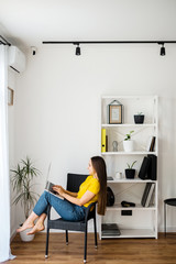 Woman in a cozy home atmosphere with a laptop