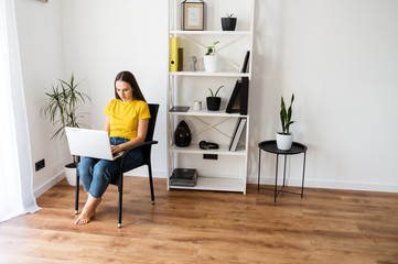 Woman in a cozy home atmosphere with a laptop