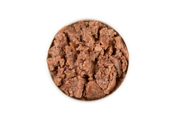 Canned pet food in round white bowl isolated on white, top view.