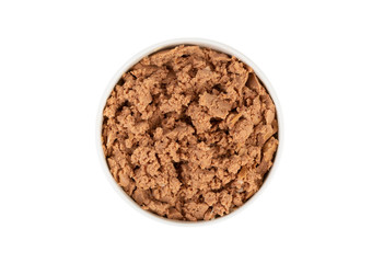 Canned pet food in round white bowl isolated on white, top view.