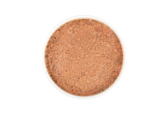 Canned pet food in round white bowl isolated on white, top view.