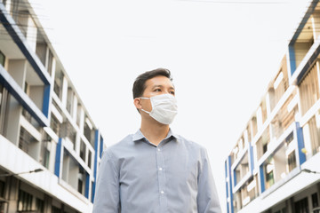 Men are standing outdoors, wearing masks to protect against germs and viruses. Prevent dust and prevent toxic fumes.