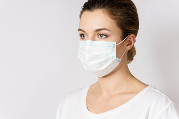 Young woman is wearing a face mask for protection against virus