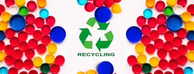 Reuse of waste. Collage with plastic bottle caps and recycling sign on white background, flat lay. Panorama