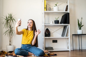 A young woman communicates via video on phone