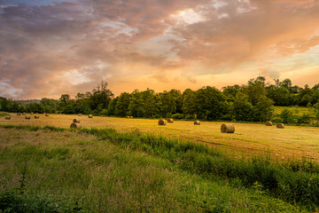 Fototapeta premium Hay bales with sunset