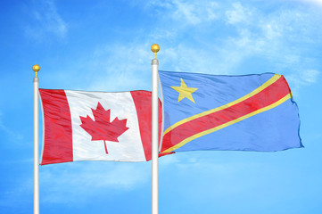 Canada and Congo Democratic Republic two flags on flagpoles and blue cloudy sky