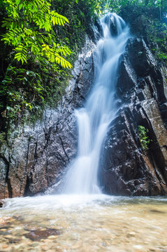 Mountain waterfall in deep tropical forest