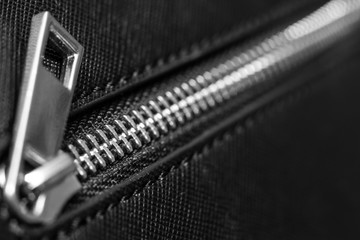 Zip fastener on black handbag
