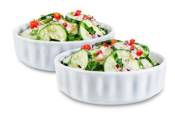 Cucumber spice salad with red onion nd red pepper on a white isolated background