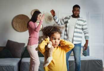 International family breaks up, child covers ears
