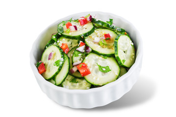 Cucumber spice salad with red onion nd red pepper on a white isolated background