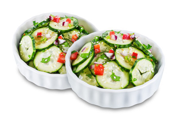 Cucumber spice salad with red onion nd red pepper on a white isolated background