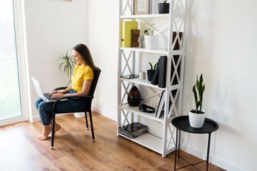 Woman in a cozy home atmosphere with a laptop