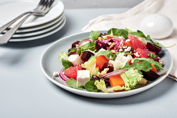 Vegetable salad with grapefruit and cheese.