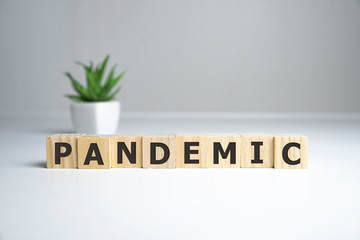 word pandemic on wooden cubes, white background, medical concept.