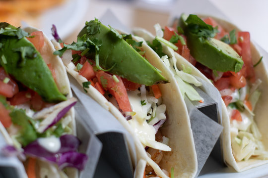 Three Spicy Shrimp Tacos with Avocado, Tomato and Red Onion Cilantro