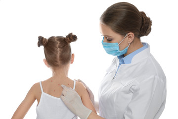 Doctor examining little girl with chickenpox on white background. Varicella zoster virus
