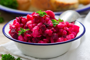 Traditional Russian lean vegetable salad vinaigrette in an iron bowl.