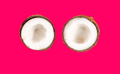two halves coconut on pink background
