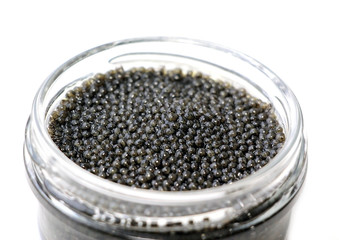 Black sturgeon caviar on a white background.