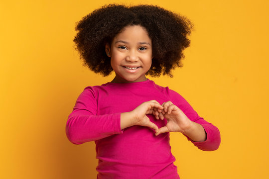 Adorable Little African American Girl Showing Heart Gesture With Hands
