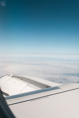 Fototapeta na wymiar Wing of an airplane during a flight against a blue sky