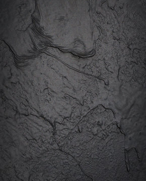 Old shabby black half painted concrete wall texture