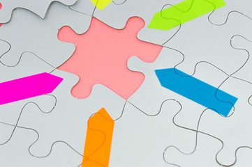 Fototapeta premium White jigsaw with color arrow sticker macro
