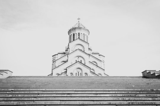 Black and white image of Holy Trinity cathedral stairs and cathedral in the background with no people. Concept of no church mass during pandemic. 2020