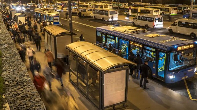 passengers waiting and boarding buses at the bus terminal, time lapse
